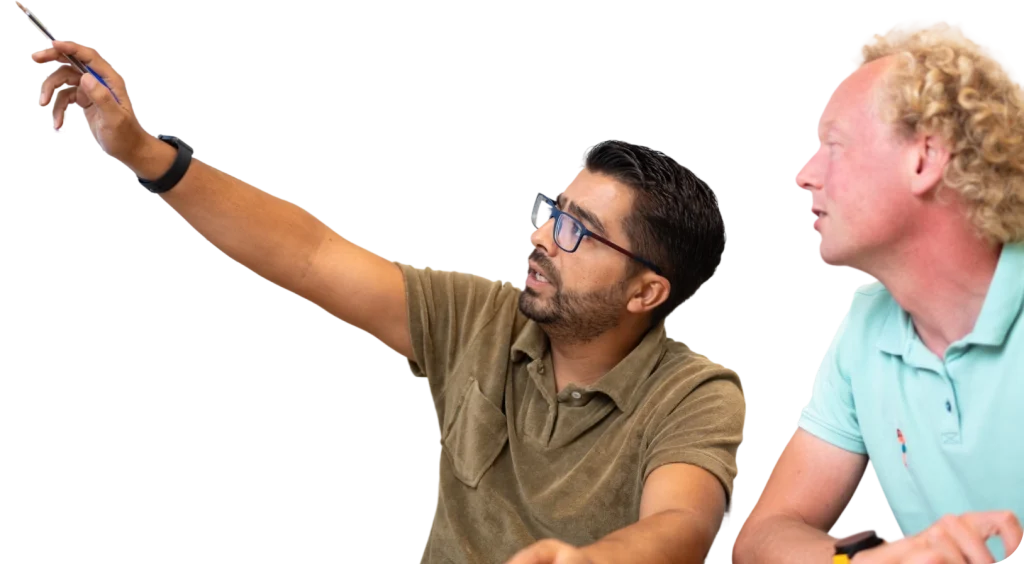 Twee mannen discussiëren en wijzen naar iets met betrekking tot een energiebeheersysteem.